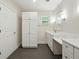 Bathroom featuring cabinets, storage, a white countertop and modern fixtures at 9269 Silver Lake Dr, Leesburg, FL 34788