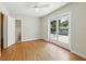 Bedroom with ceiling fan and french doors leading to a backyard pool and outdoor patio area at 9269 Silver Lake Dr, Leesburg, FL 34788