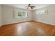 Bedroom with windows and original hardwood floors throughout the room at 9269 Silver Lake Dr, Leesburg, FL 34788