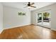 Bedroom with window, ceiling fan, and french doors leading to a backyard patio at 9269 Silver Lake Dr, Leesburg, FL 34788