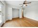 Bedroom with ceiling fan, french doors, large closet with bi-fold doors and original hardwood floors at 9269 Silver Lake Dr, Leesburg, FL 34788