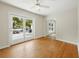 Bright bedroom with ceiling fan and doors leading to the backyard pool and outdoor patio area at 9269 Silver Lake Dr, Leesburg, FL 34788