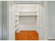 Walk-in closet with bi-fold doors, shelves, and hanging rod at 9269 Silver Lake Dr, Leesburg, FL 34788