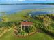 Aerial view of private dock on the water, surrounded by lily pads and lush greenery at 9269 Silver Lake Dr, Leesburg, FL 34788