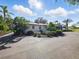 Rear exterior showing well-maintained lawn and garden at 9269 Silver Lake Dr, Leesburg, FL 34788