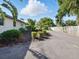 Home exterior showing a well-maintained driveway, manicured bushes, and partial wooden fence offering privacy at 9269 Silver Lake Dr, Leesburg, FL 34788