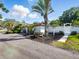 Charming home exterior with a picnic table, white fence, and lush tropical landscaping for a relaxing outdoor space at 9269 Silver Lake Dr, Leesburg, FL 34788