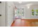 Bright foyer featuring patterned floors, an eye-catching accent wall, and views to the front porch at 9269 Silver Lake Dr, Leesburg, FL 34788