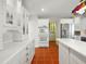 Modern kitchen features stainless steel appliances, custom cabinets, and a terracotta-tiled floor at 9269 Silver Lake Dr, Leesburg, FL 34788