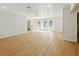 Sunlit living room boasts wood-look flooring, paneled ceiling, and french doors leading to outdoor space at 9269 Silver Lake Dr, Leesburg, FL 34788