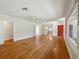 Bright, airy living room showcasing hardwood floors and ample natural light from large windows at 9269 Silver Lake Dr, Leesburg, FL 34788