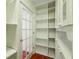 Pantry featuring ample shelving, cabinets and a glass panel door at 9269 Silver Lake Dr, Leesburg, FL 34788