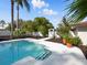 The beautiful pool features stairs and gorgeous landscaping, offering a tropical paradise at 9269 Silver Lake Dr, Leesburg, FL 34788