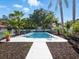 Inviting pool with a concrete walkway and lush tropical landscaping surrounding the area at 9269 Silver Lake Dr, Leesburg, FL 34788