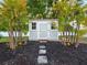 Charming storage shed surrounded by tropical plants adds beauty and storage at 9269 Silver Lake Dr, Leesburg, FL 34788