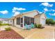 Cozy screened-in porch with beautiful stone-paved patio seating area, ideal for relaxing outdoors at 992 Davit Pl, The Villages, FL 32162