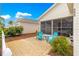 Charming patio space with cozy seating, manicured landscaping, and sunny backyard views at 992 Davit Pl, The Villages, FL 32162