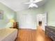 Bedroom with vaulted ceiling, wood floor, double closet and a view of the living area at 992 Davit Pl, The Villages, FL 32162
