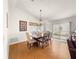 Bright dining area featuring hardwood floors, a charming chandelier, and sliding glass doors at 992 Davit Pl, The Villages, FL 32162