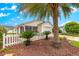 Beautiful single-story home featuring mature palm trees, manicured landscaping, and a welcoming exterior at 992 Davit Pl, The Villages, FL 32162