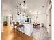 The bright kitchen features white cabinets, granite countertops, and a breakfast bar at 992 Davit Pl, The Villages, FL 32162