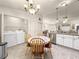 Open kitchen and dining area featuring tile floors and modern appliances at 992 Davit Pl, The Villages, FL 32162