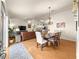 Bright open-concept living and dining area with hardwood floors, creating a warm and inviting atmosphere at 992 Davit Pl, The Villages, FL 32162