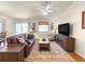 Comfortable living room featuring a leather sofa, area rug, and ceiling fan at 992 Davit Pl, The Villages, FL 32162