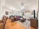 Open-concept living space with hardwood floors, comfortable seating, and modern lighting at 992 Davit Pl, The Villages, FL 32162