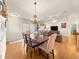 Dining area with hardwood floors, chandelier and large windows at 992 Davit Pl, The Villages, FL 32162