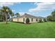 Beautiful backyard featuring lush lawn, mature trees, and a well-maintained home exterior at 10046 Ketch Kay Ln, Oxford, FL 34484