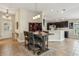 Elegant dining area with a wooden table, seating for four, and open access to the modern kitchen at 10046 Ketch Kay Ln, Oxford, FL 34484