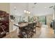 Open-concept dining area featuring a rustic table and chairs, seamlessly connected to the kitchen and living room at 10046 Ketch Kay Ln, Oxford, FL 34484