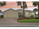 Charming single-story home with a brick driveway, well-manicured landscaping, and a two-car garage at 10046 Ketch Kay Ln, Oxford, FL 34484