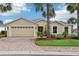 Charming single-story home with a brick driveway, well-manicured landscaping, and a two-car garage at 10046 Ketch Kay Ln, Oxford, FL 34484