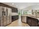 Modern kitchen with stainless steel appliances, granite countertops, and dark cabinetry at 10046 Ketch Kay Ln, Oxford, FL 34484