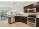 Kitchen featuring stainless steel appliances, tile flooring, and granite countertops at 10046 Ketch Kay Ln, Oxford, FL 34484