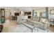 Open-concept living room features stylish furniture, neutral decor, and seamless access to the kitchen at 10046 Ketch Kay Ln, Oxford, FL 34484