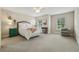 Spacious main bedroom with large windows, soft carpet, and comfortable furnishings at 10046 Ketch Kay Ln, Oxford, FL 34484