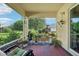 Relaxing screened patio with plants, comfortable seating, and serene backyard views at 10046 Ketch Kay Ln, Oxford, FL 34484