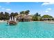 Community pool featuring waterfall feature and ample lounge chairs at 10046 Ketch Kay Ln, Oxford, FL 34484