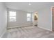 Bright bedroom features neutral carpet, two windows, and an ensuite bathroom at 10302 Pearson Ave, Orlando, FL 32827