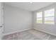 Bedroom features two windows and neutral carpet creating a comfortable living space at 10302 Pearson Ave, Orlando, FL 32827