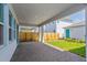 Long carport with brick pavers, connecting the home to a back building with grassy yard at 10302 Pearson Ave, Orlando, FL 32827