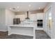Beautiful kitchen featuring stainless steel appliances, white cabinets, quartz countertops, and a kitchen island at 10302 Pearson Ave, Orlando, FL 32827