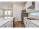 Modern kitchen featuring stainless steel appliances, white cabinets, quartz counters, and eat-in island at 10302 Pearson Ave, Orlando, FL 32827