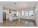 Modern kitchen with stainless steel appliances, white cabinets, and an island with seating at 10302 Pearson Ave, Orlando, FL 32827