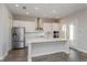 Stylish kitchen featuring white cabinets, stainless steel appliances, quartz countertops, and a center island at 10302 Pearson Ave, Orlando, FL 32827