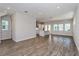 Bright and airy living space featuring luxury vinyl plank floors, recessed lights, and kitchen access at 10302 Pearson Ave, Orlando, FL 32827