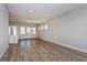 Bright living room featuring luxury vinyl plank flooring, recessed lights, and access to the kitchen at 10302 Pearson Ave, Orlando, FL 32827
